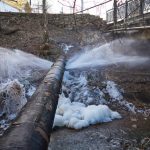 water pressure from a large pipe over the river